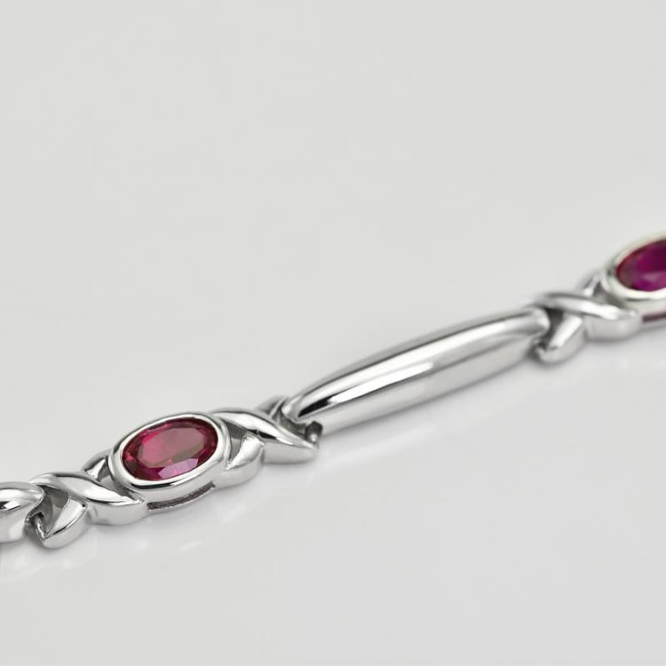 Stříbrný náramek s rubíny 21787